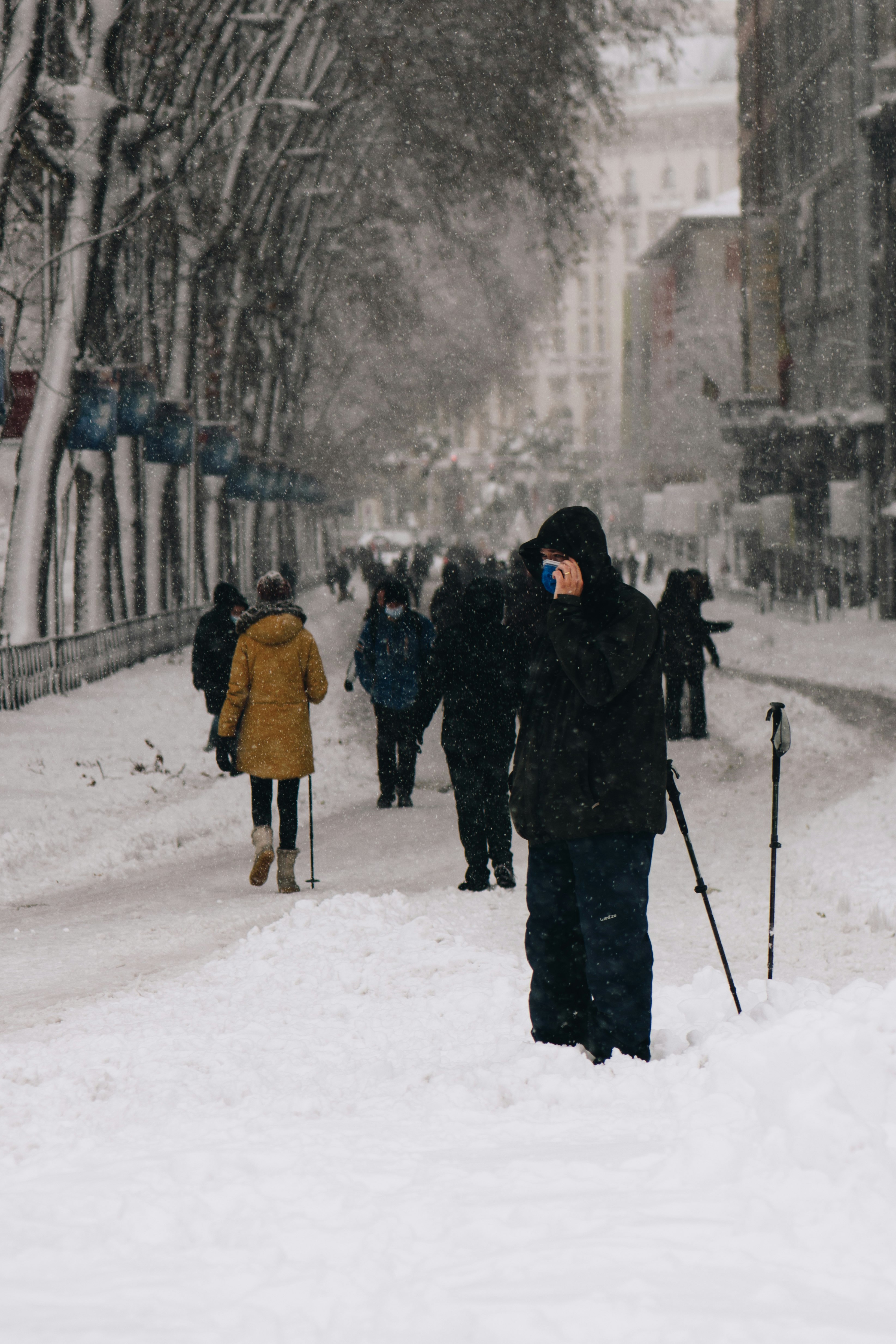 people walking on snow covered ground during daytime